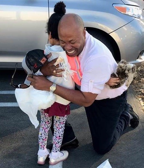 Herb Legall hugs his daughter