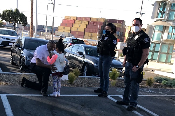 Senior Investigators Rodriguera and Albo watch Herb Legall reunite with daughter.