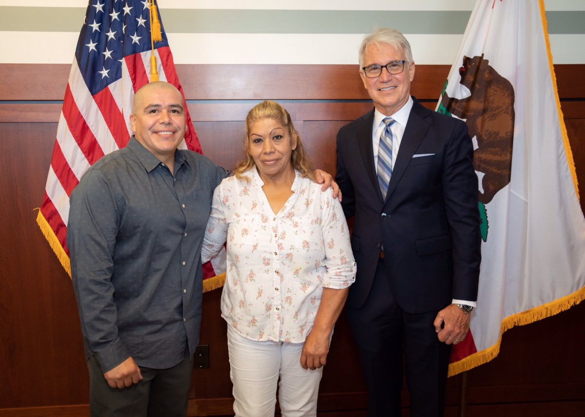 Image of District Attorney Gascon with Alexander Torres and his mother